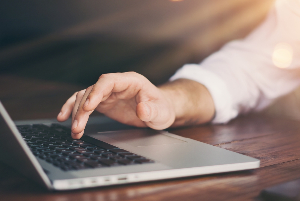 image of hand typing on keyboard